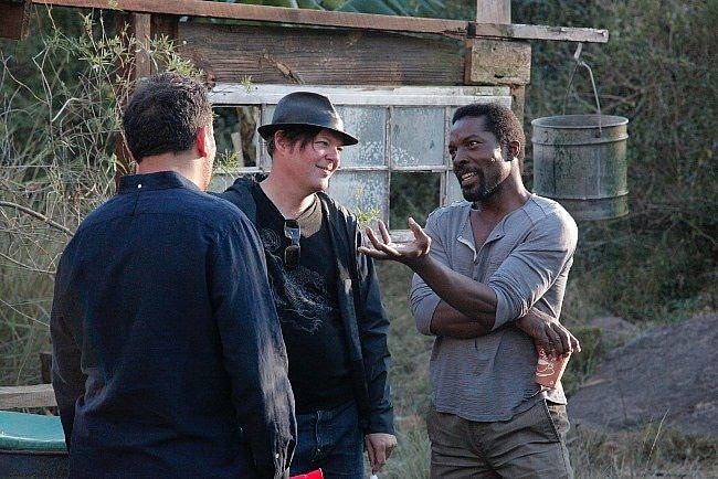 Isaach De Bankolé (far right) chats with crew on set