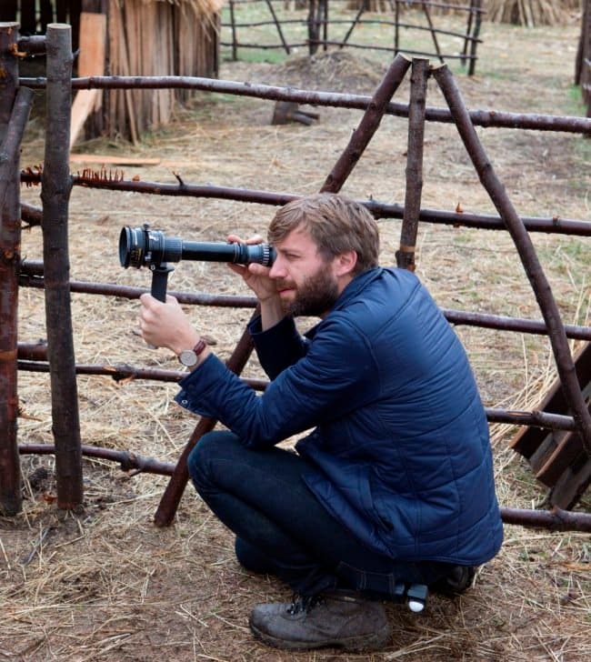 DP Jarin Blaschke holds a viewfinder up to The Witch’s entirely purpose-built set