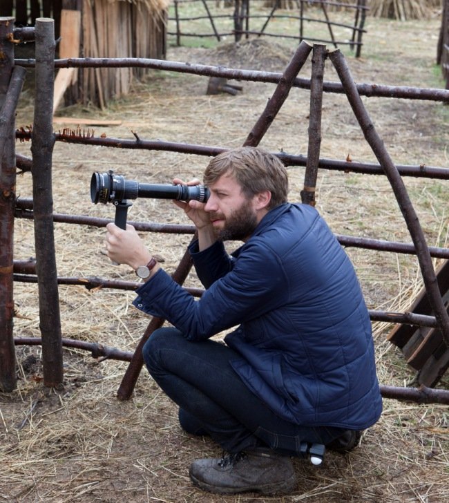 DP Jarin Blaschke holds a viewfinder up to The Witch’s entirely purpose-built set